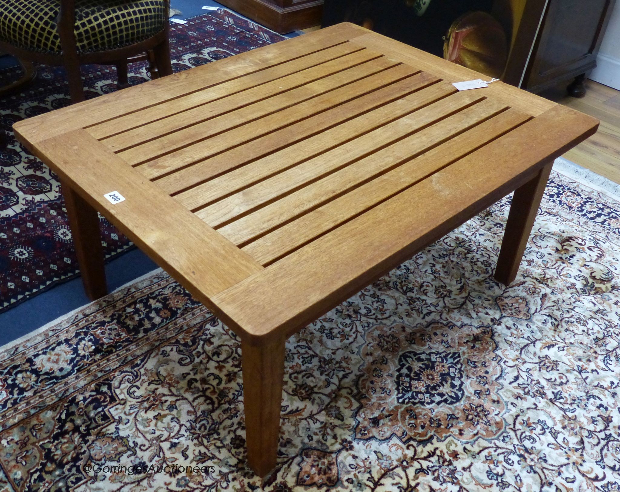 A teak low garden table, width 90cm, depth 70cm, height 42cm